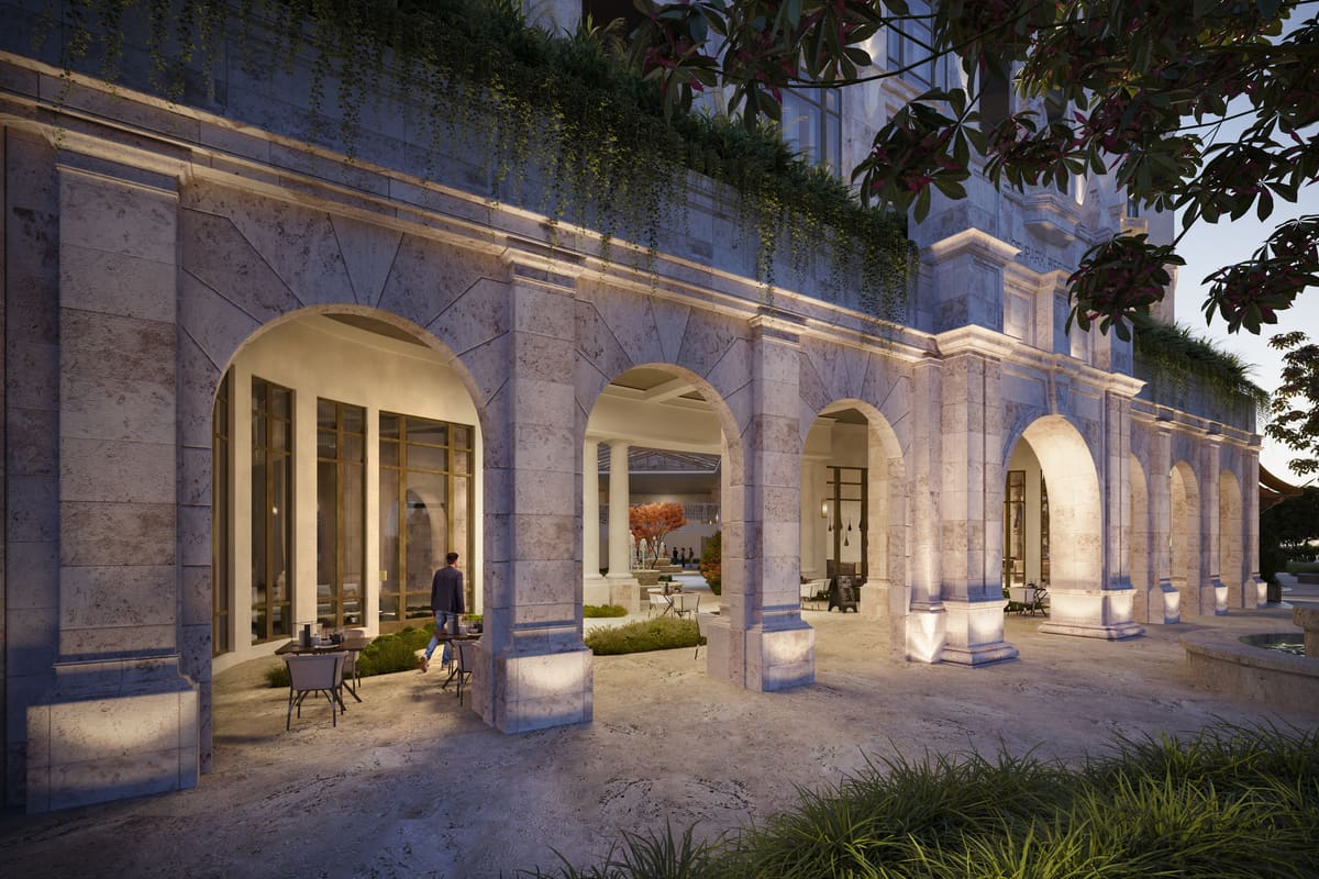 The ground-floor stone arcade at Ponce Park Residences, opening onto the landscaped park