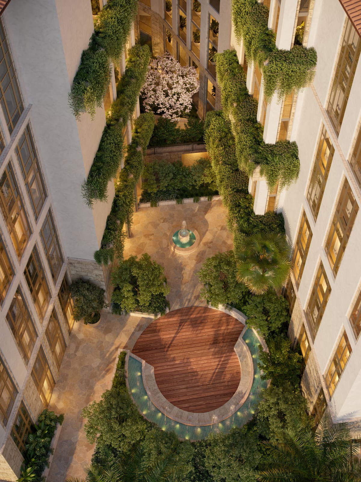 The planted interior courtyard at Ponce Park Residences seen from above, with a fountain at its centre