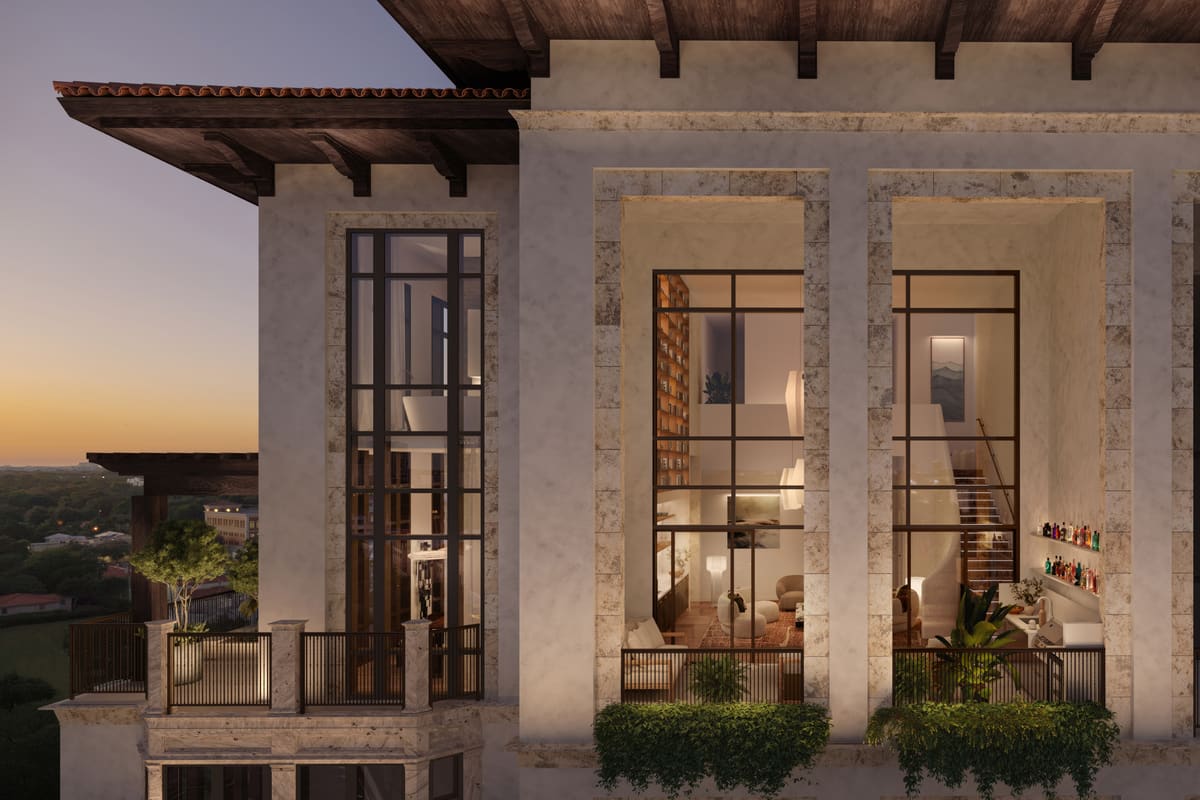 A Ponce Park penthouse seen from outside at dusk, its two levels lit behind full-height arched glazing