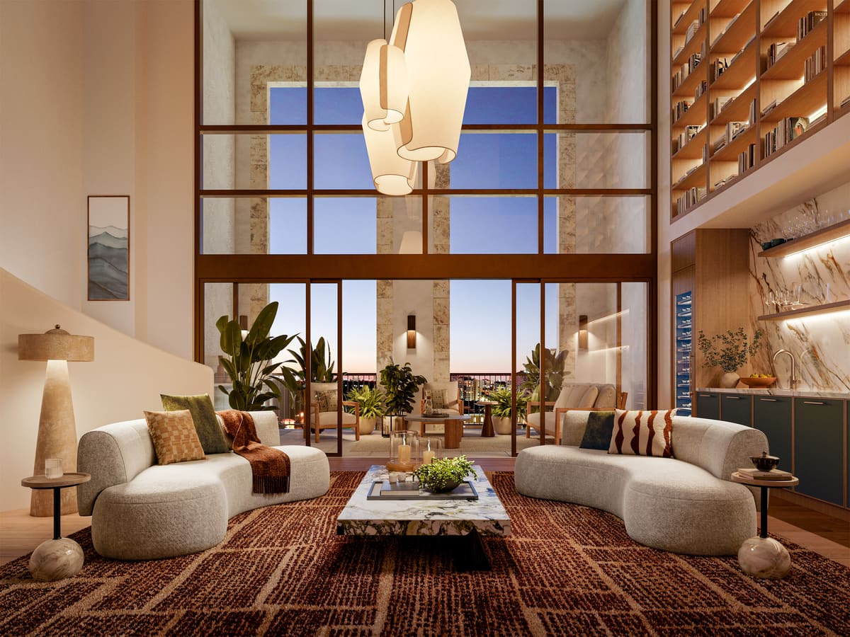The double-height living room of a Ponce Park penthouse, with a mezzanine library above