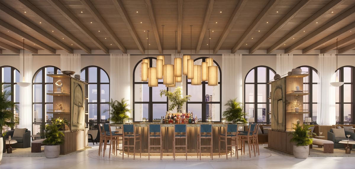 The staffed rooftop bar and lounge at Ponce Park Residences, with arched windows and pendant lighting