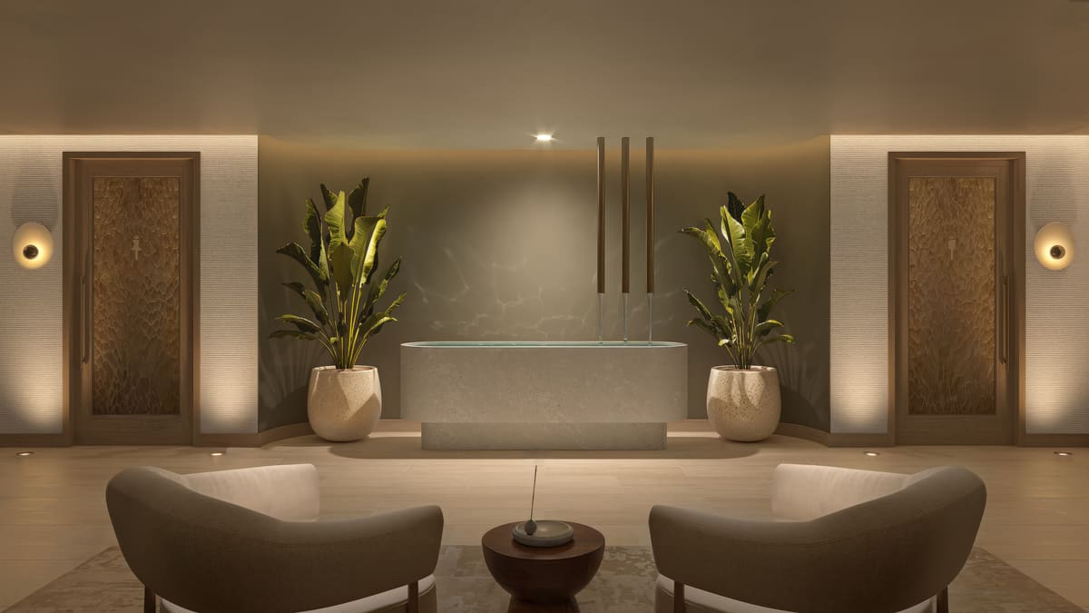 The wellness spa at Ponce Park Residences, a stone bathing room lit by a recessed arch