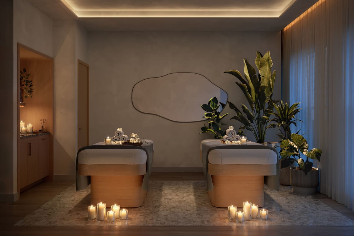 A private treatment suite at Ponce Park Residences set for two, lit by candles