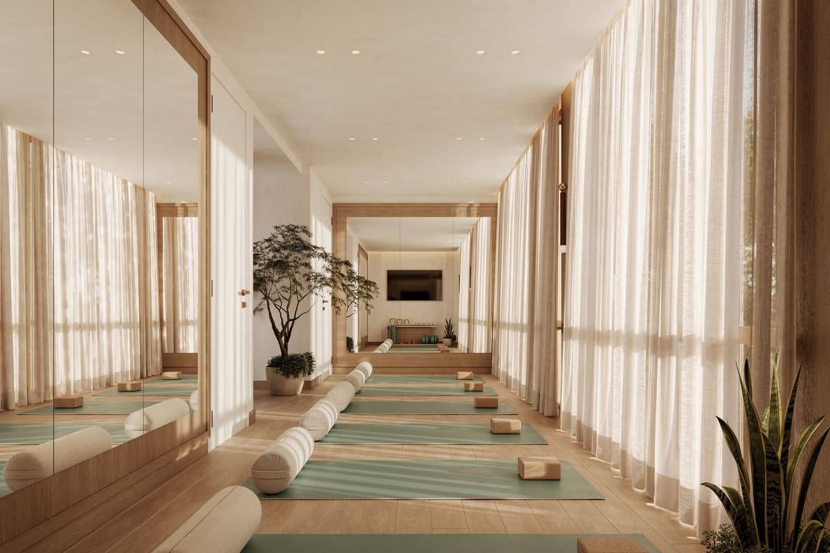 The mirrored movement studio at Ponce Park Residences, with mats laid out beneath draped windows